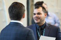 Naval Surface Warfare Center, Philadelphia Division Technology Deployment Branch manager  Jose Rosario speaks with a potential candidate during the NSWCPD career fair at Penn State on the Navy Yard in Philadelphia on Dec. 14, 2022. Career fairs are important to the Navy because they help fill vital positions. (U.S. Navy photo by Sgt. Jermaine Sullivan/Released)
