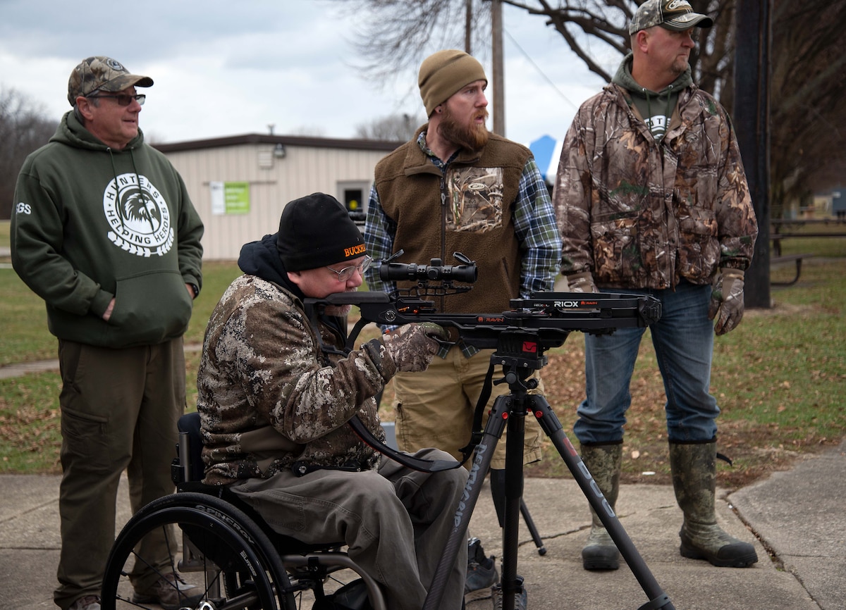 A hunter sets the sights on his crossbow.