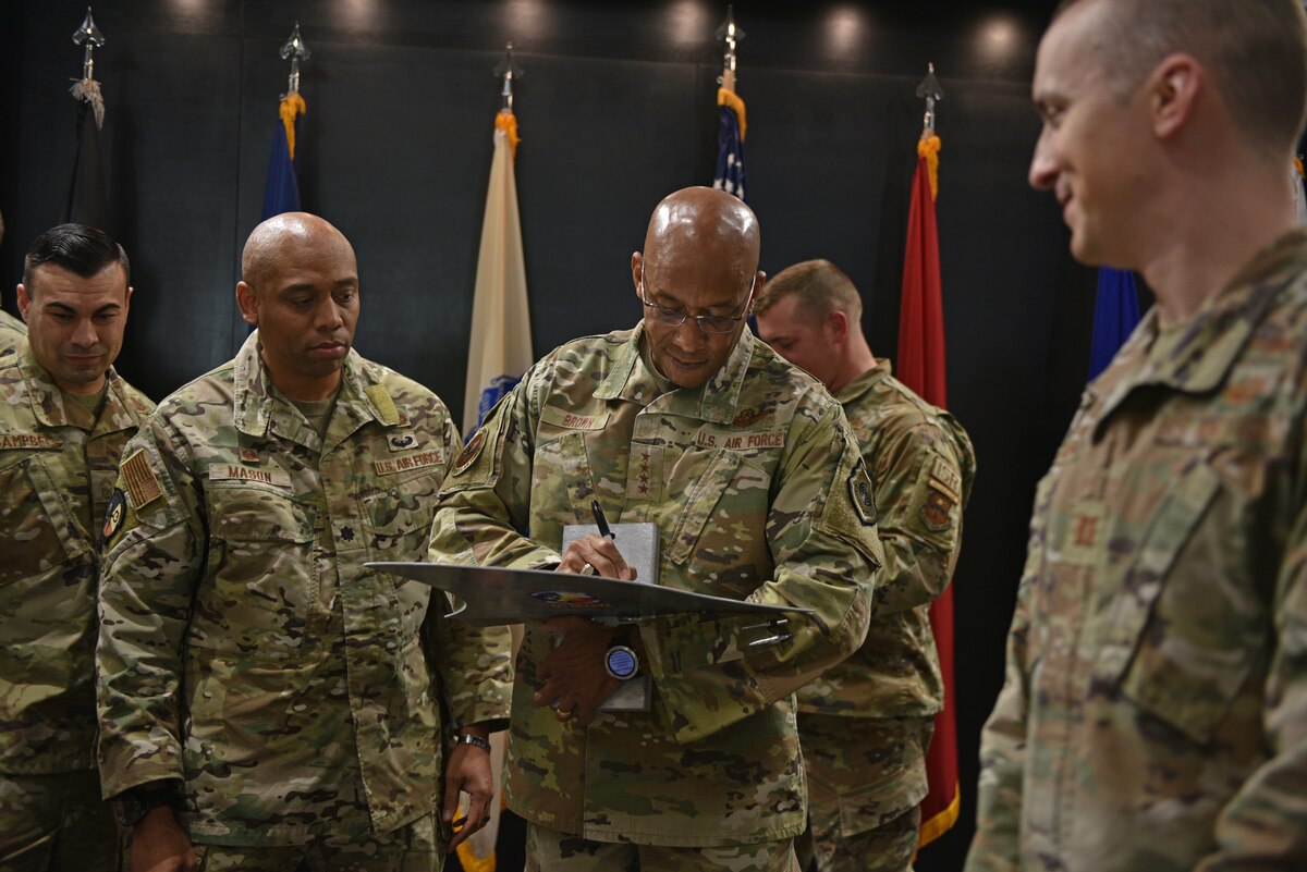 U.S. Air Force Chief of Staff Gen. CQ Brown Jr. signs a shark fin at the Powell Event Center, Goodfellow Air Force Base, Texas, Dec. 12, 2022. Signing the shark fin is a tradition for all distinguished visitors of the 316th Training Squadron. (U.S. Air Force photo by Senior Airman Ashley Thrash)