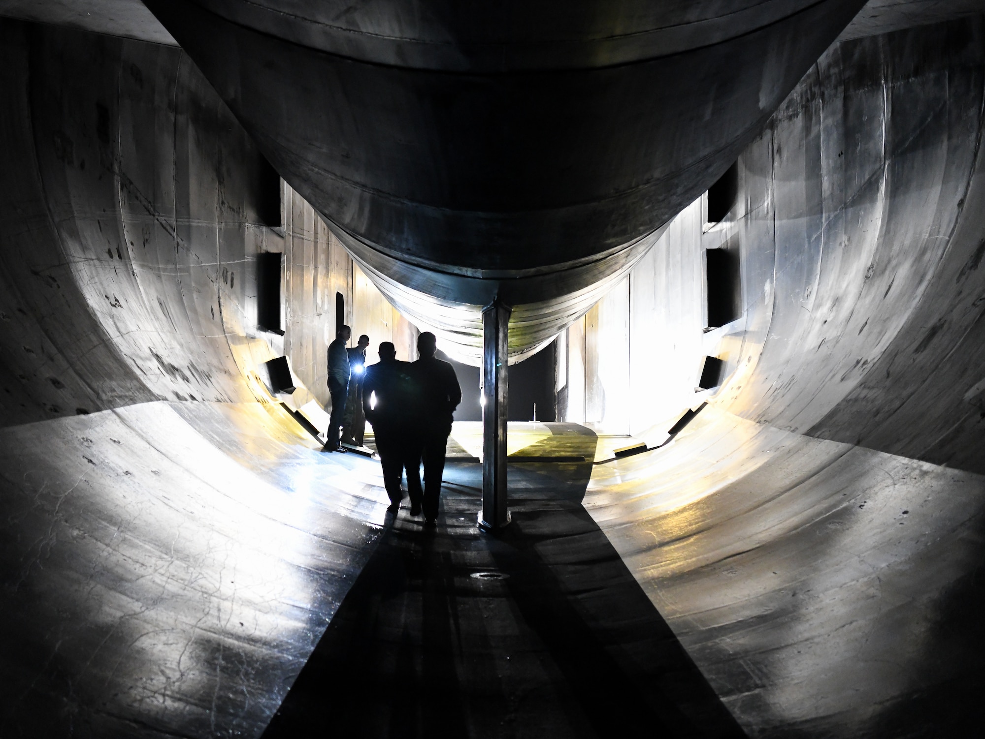 Air Force Test Center technical leaders walk through the 16-foot transonic wind tunnel at Arnold Air Force Base, Tennessee.