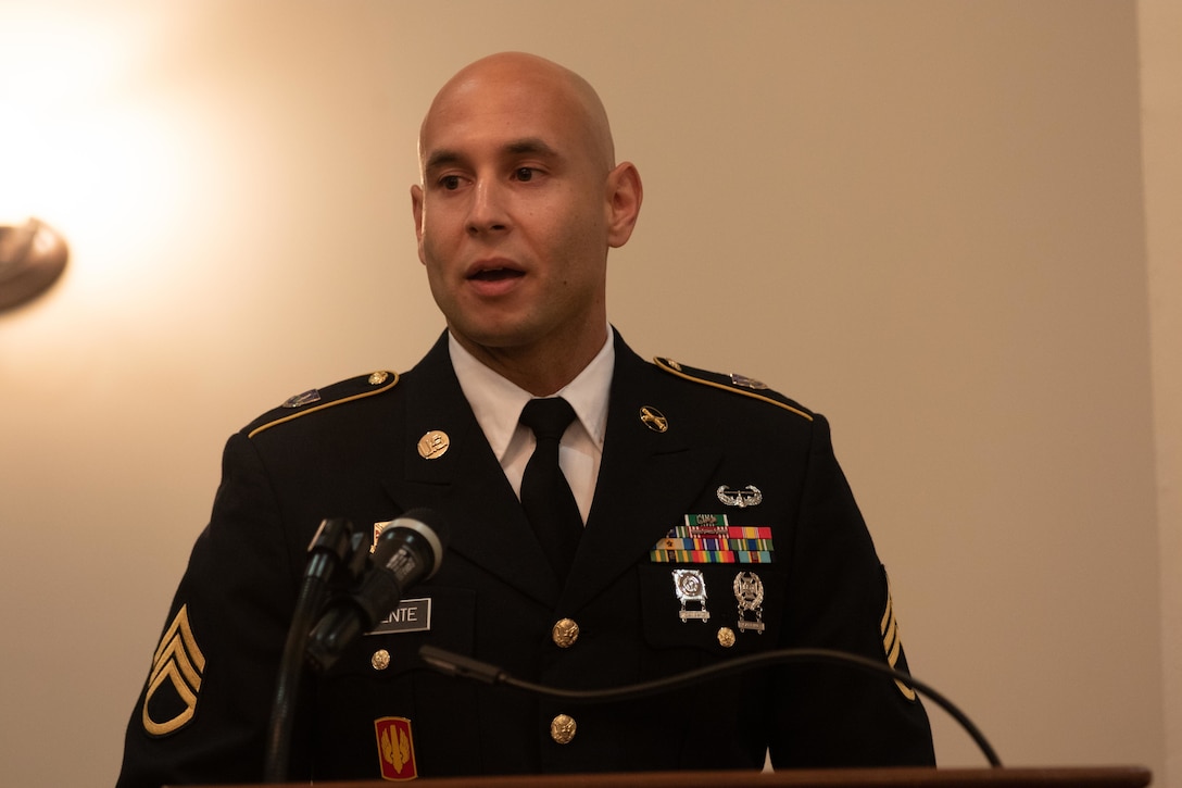 Staff Sgt. Maximo Vincente, an observer, coach/trainer with the 3rd Battalion, 314th Field Artillery Regiment, 174th Infantry Brigade, talks about his life growing up in both the United States and the Dominican Republic at a Hispanic Heritage Observance, Oct. 5, 2022, at Joint Base McGuire-Dix-Lakehurst, New Jersey.