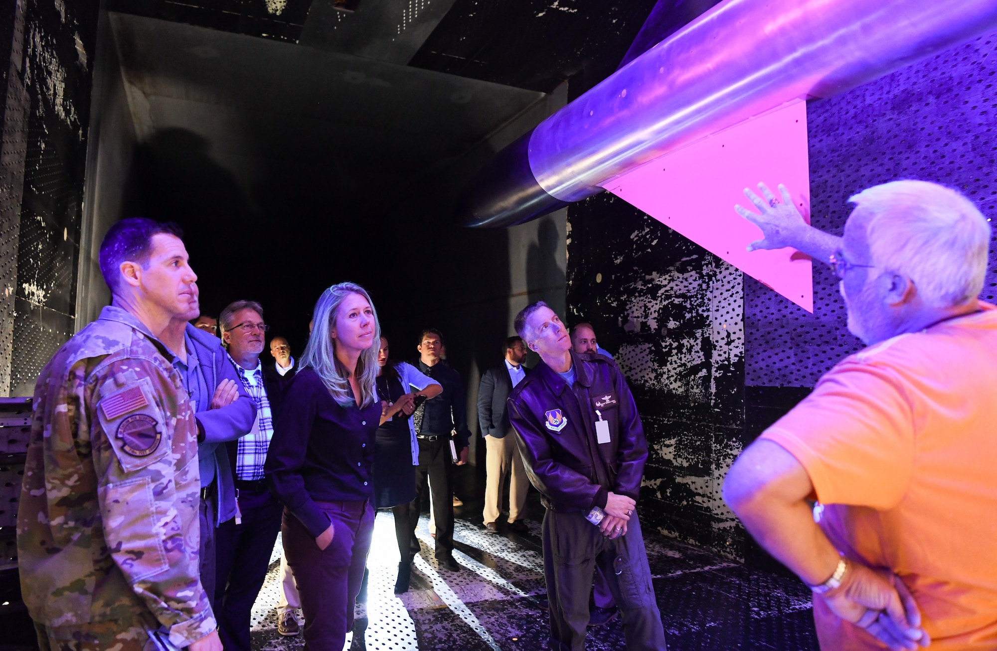 Marvin Sellers, right, an Arnold Engineering Development Complex subject matter expert with the 716th Test Squadron, speaks about the use of pressure sensitive paint in wind tunnel testing to Air Force Test Center technical leaders standing at left.