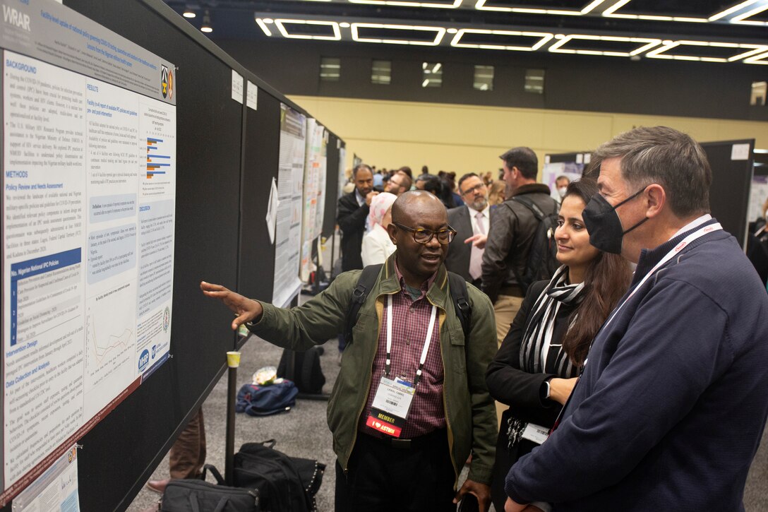 Member speaks with attendees during ASTMH annual meeting.