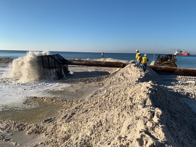 Dredge pumping sand on to beach