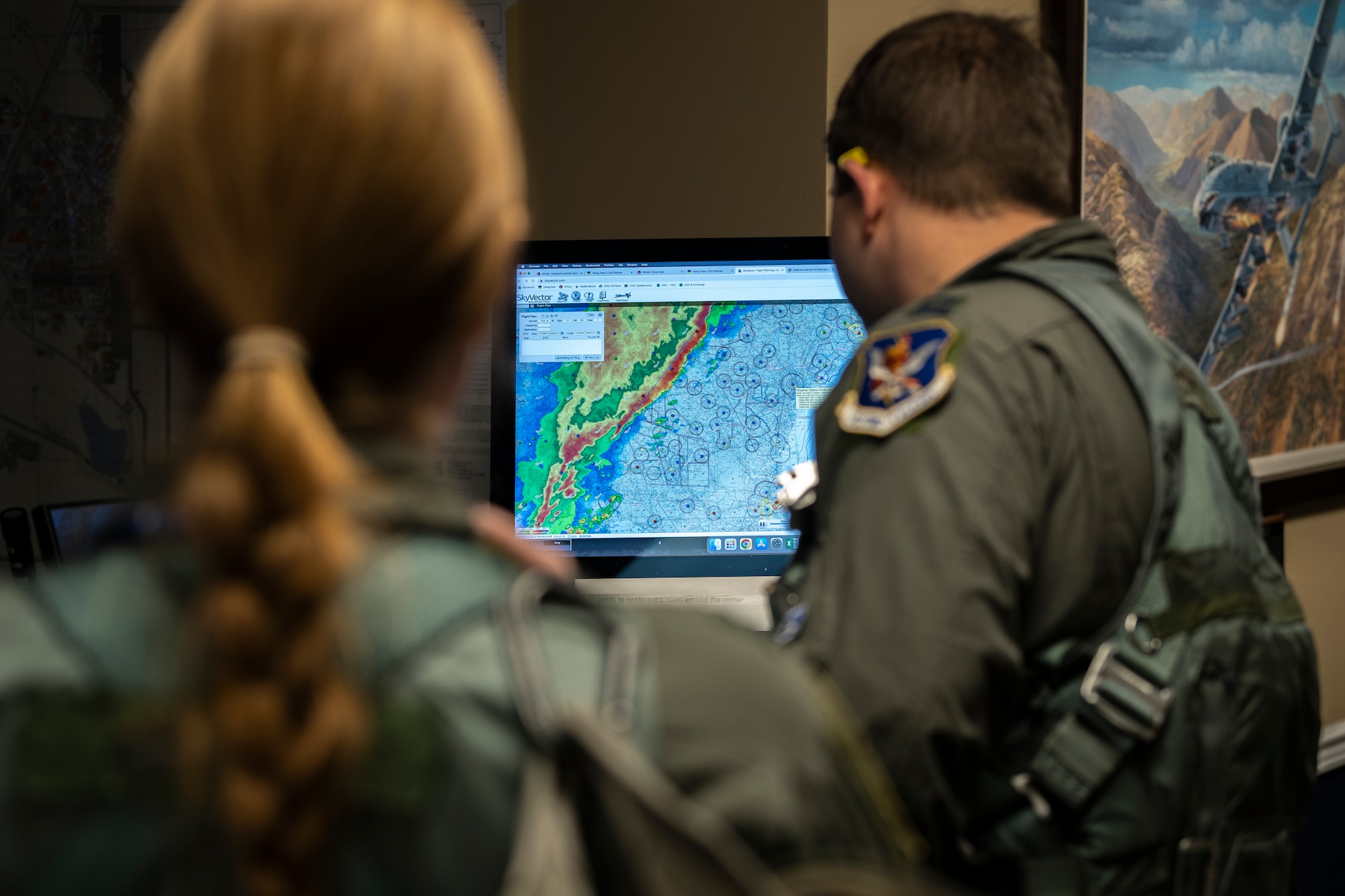 Pilots review a weather radar.