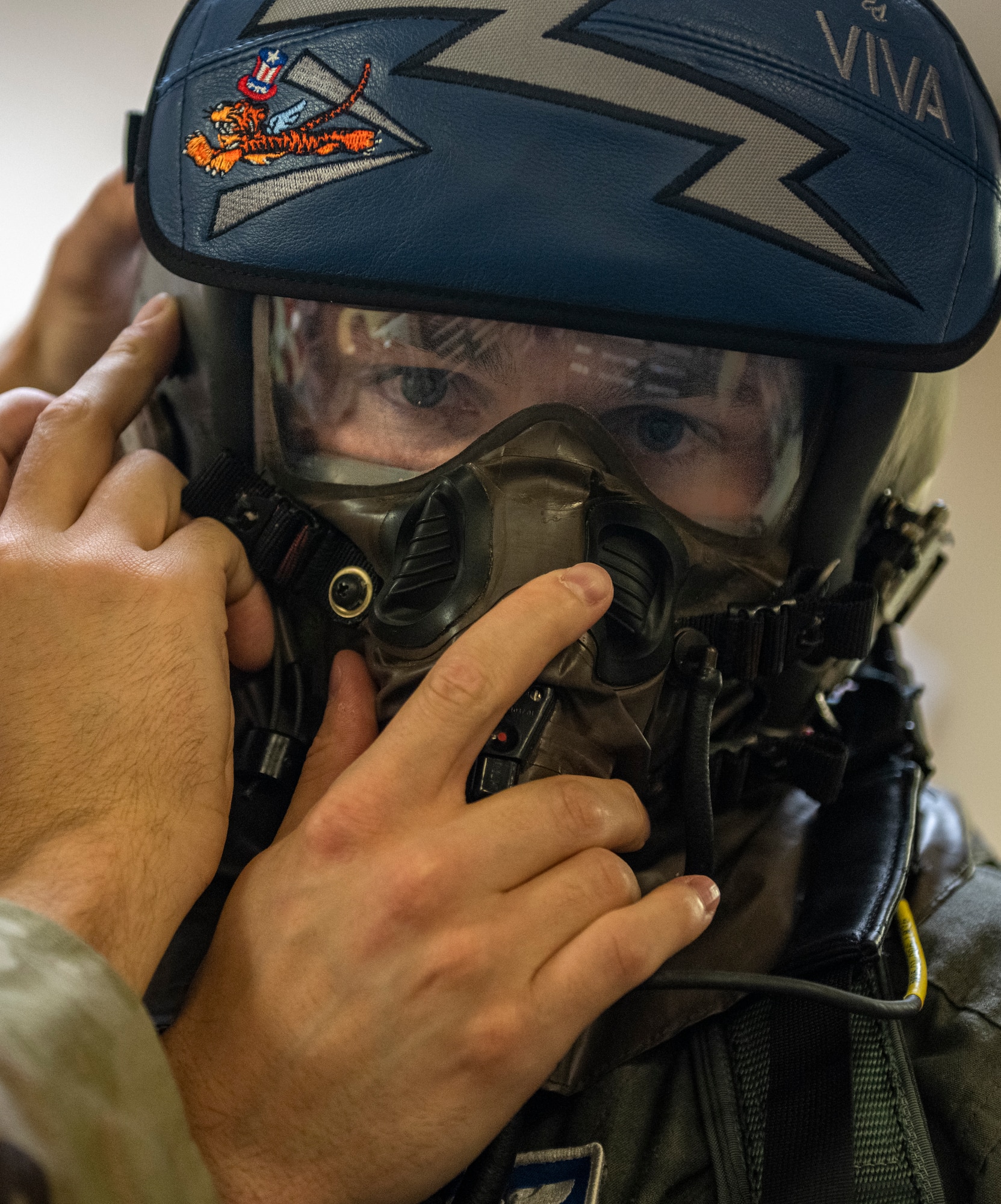 U.S. Air Force Tech. Sgt. Levi Schafer, 23rd Operation Support Squadron aircrew flight equipment inspection shop noncommissioned officer in charge, secures the mask of 1st Lt. James McMahon, 74th Fighter Squadron A-10C Thunderbolt II pilot, at Moody Air Force Base, Georgia, Jan. 5, 2023.