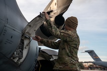 An Airman prepares a C-17 Globemaster III for refueling.