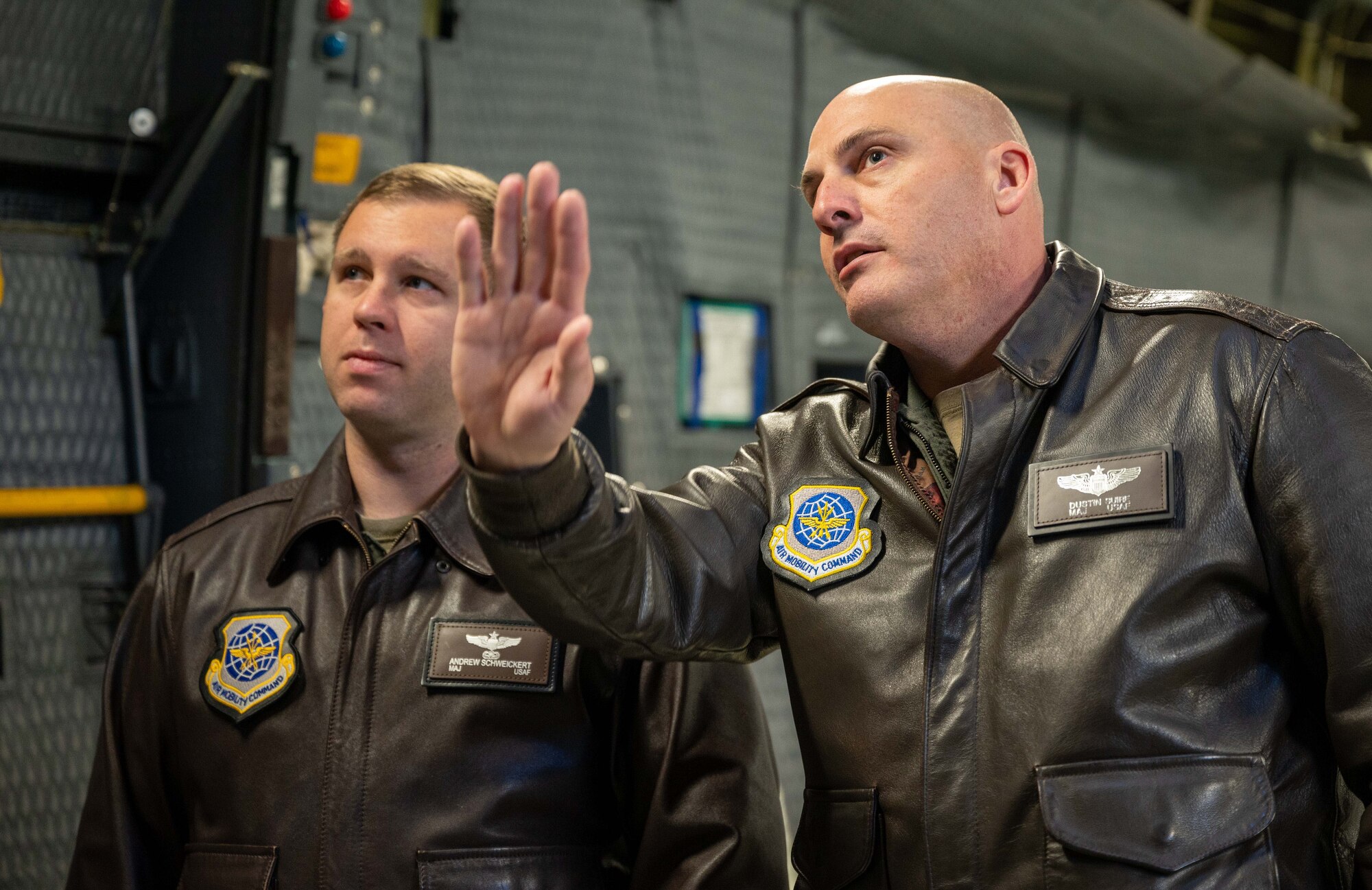 Maj. Dustin Suire, right, 436th Operations Group C-5M Super Galaxy standardization and evaluation chief, explains the cargo capabilities of a C-5 to Maj. Andrew Schweickert, 436th OG C-17 Globemaster III standardization and evaluation chief, before a local training flight at Dover Air Force Base, Delaware, Nov. 22, 2022. Schweickert, originally a C-17 pilot, was the first aircrew to participate in the Instructor Enrichment Program at Dover AFB, which gives instructor aircrew the chance to fly in a different airframe. (U.S. Air Force photo by Senior Airman Cydney Lee)