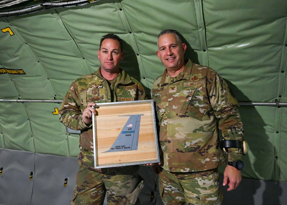 Airmen hold plaque