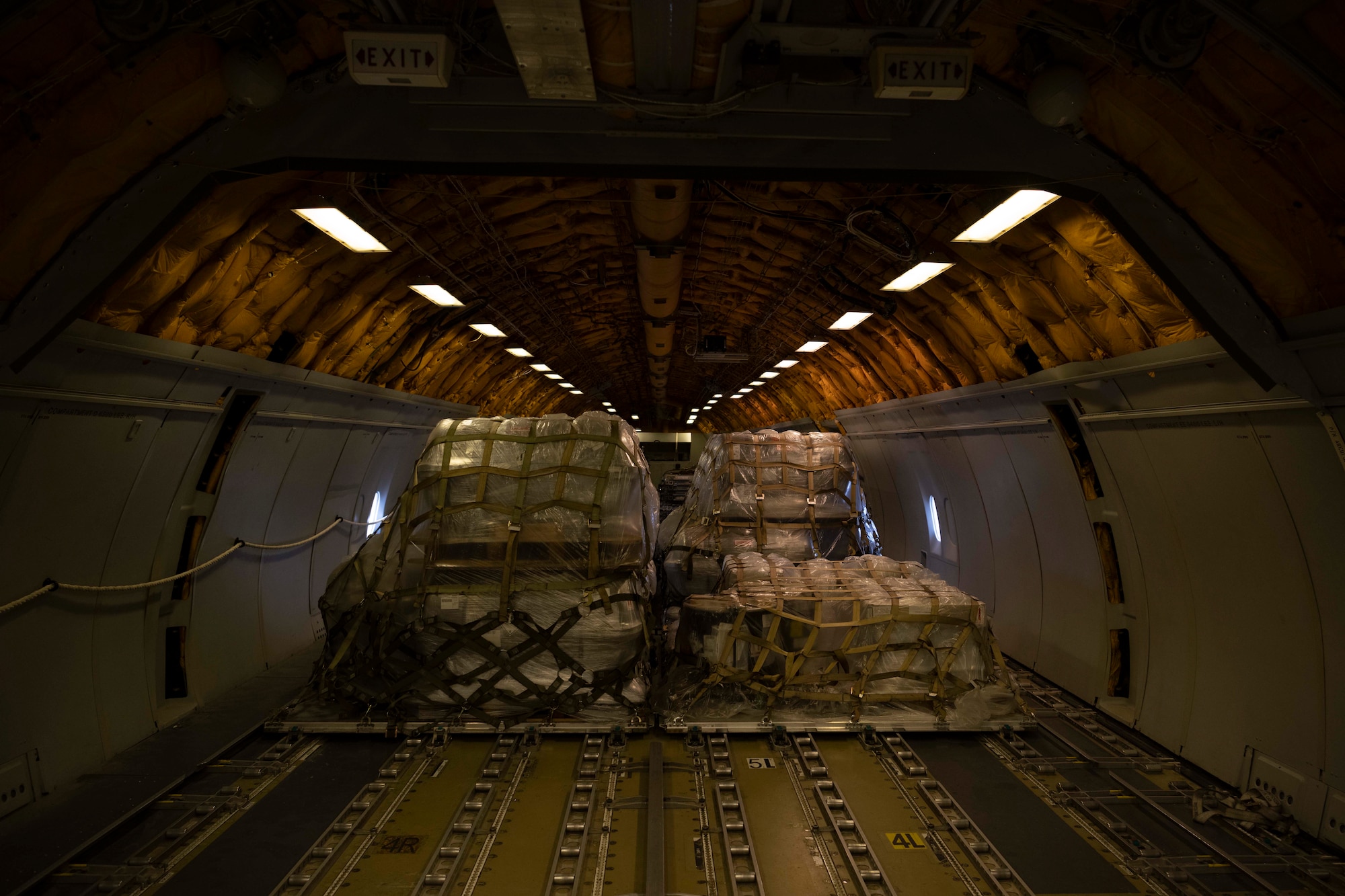 Pallets of cargo inside a military aircraft.