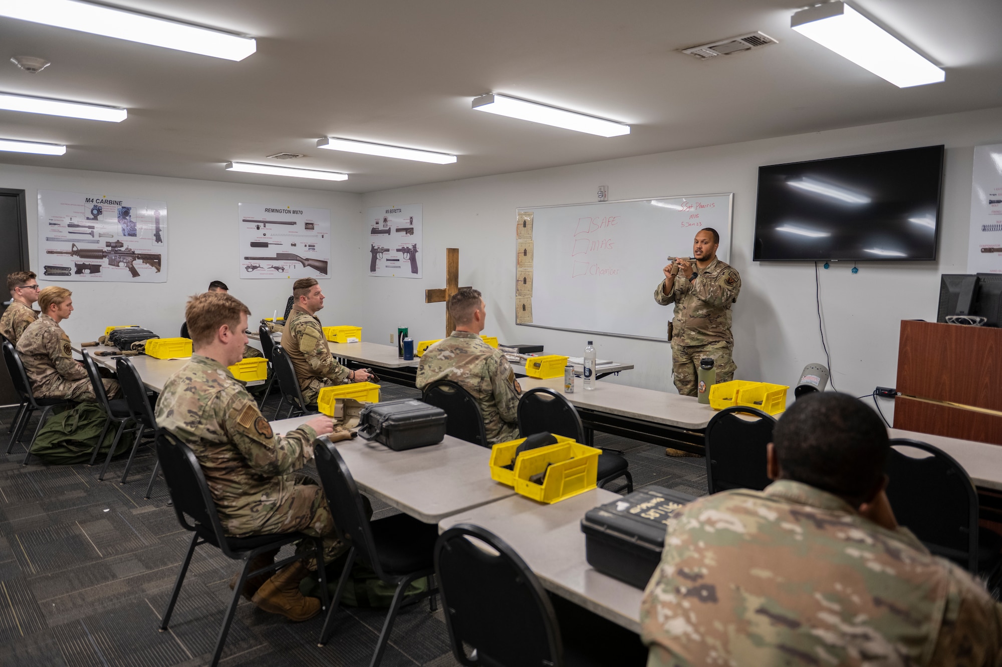 U.S. Air Force Staff Sgt. Nolan Pharris, 23rd Security Forces Squadron Combat Arms Training and Maintenance instructor, conducts an M18 Modular Handgun System qualification class