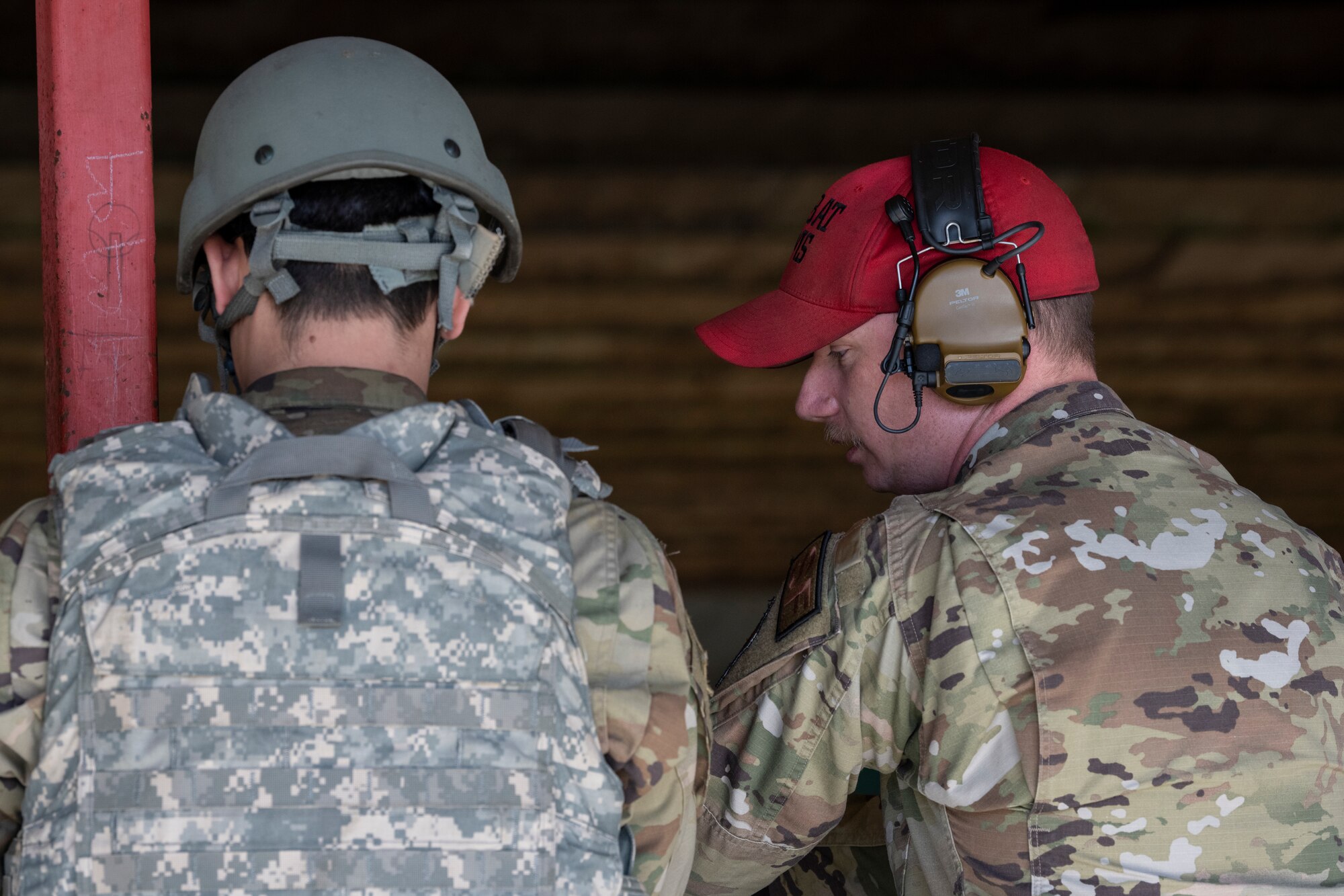 An instructor assists an Airman during qualification class.