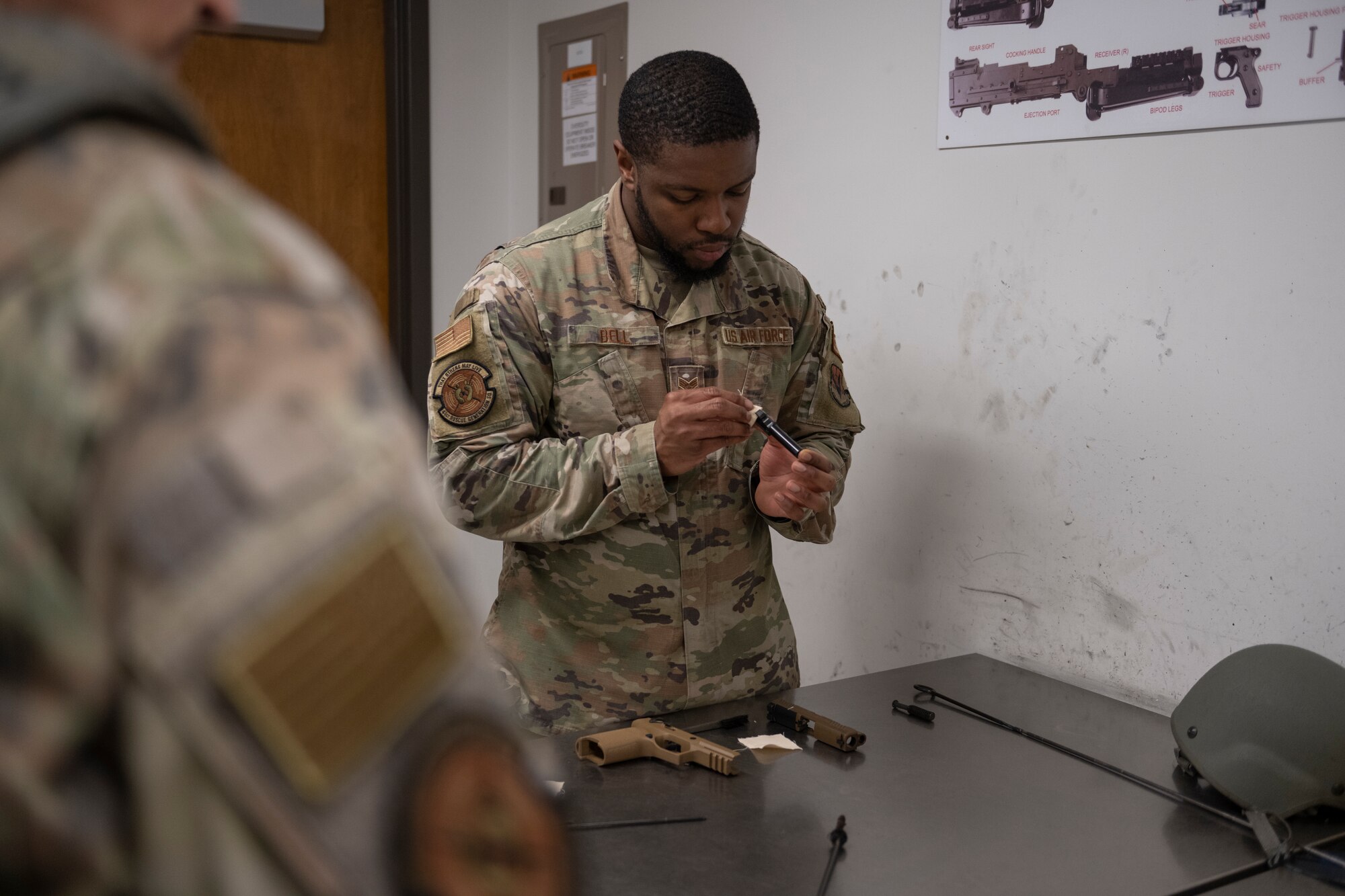An Airman cleans an M18.