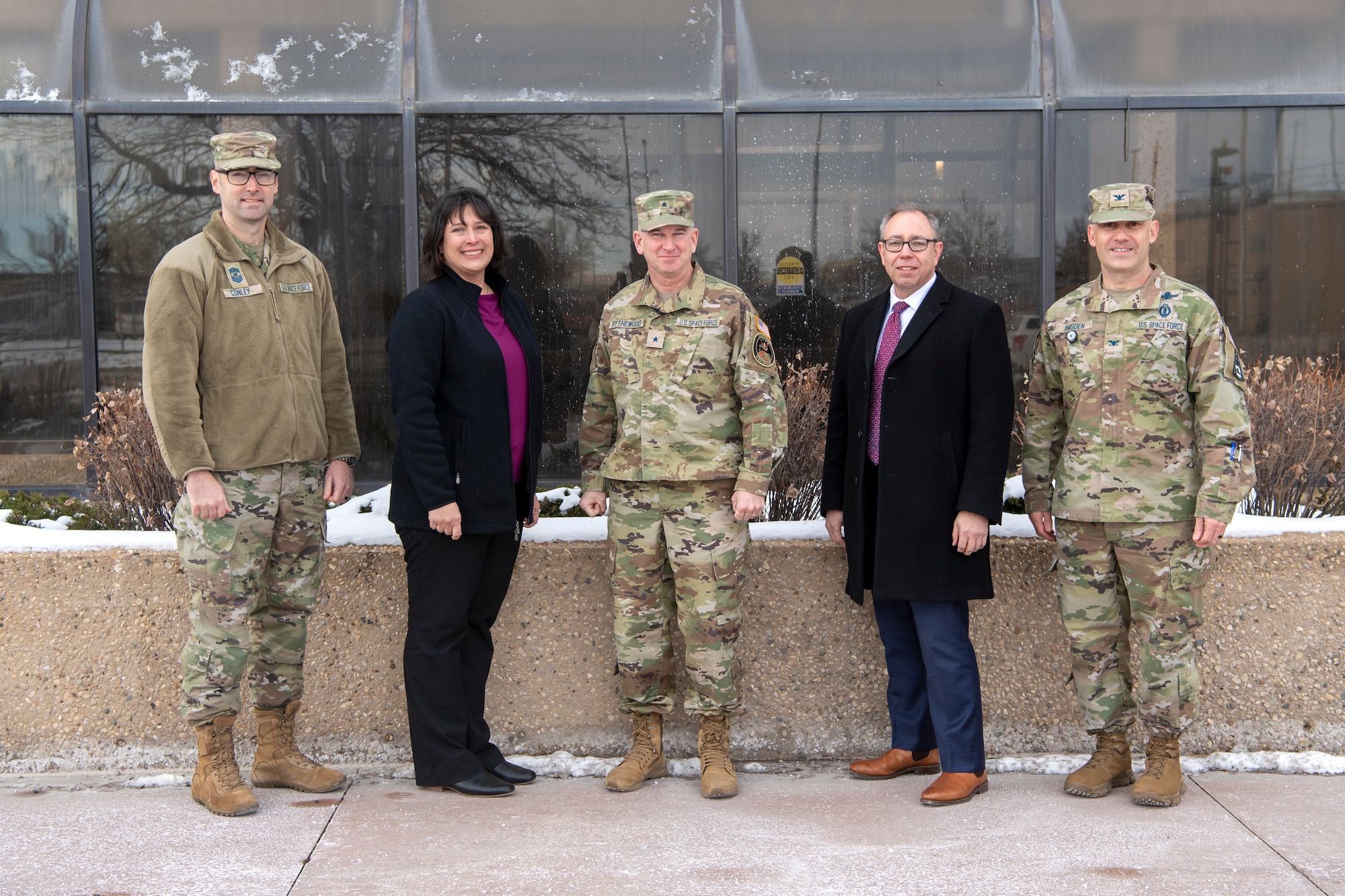 Military members and civilians pose for a group photo