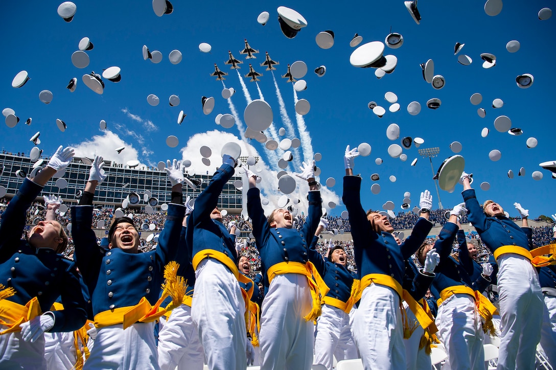 The U.S. Air Force Academy Class of 2022 graduates toss their hats into the sky