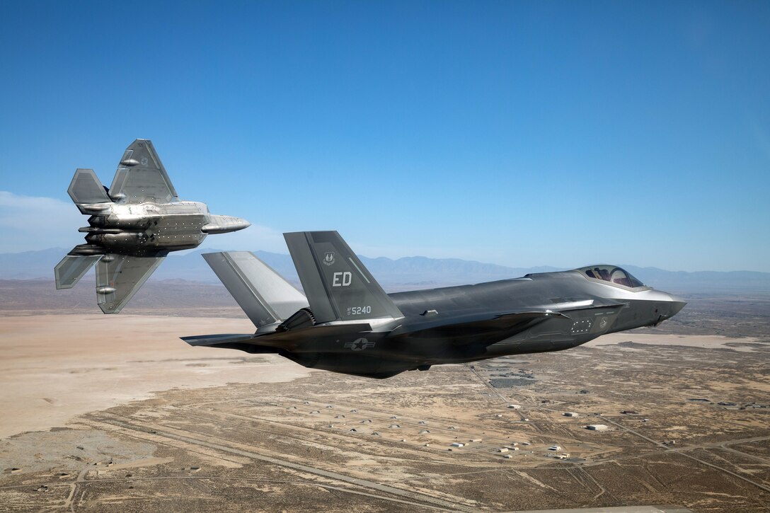 An F-22 Raptor from the 411th Flight Test Squadron and an F-35 Lightning II return to Edwards Air Force Base, California