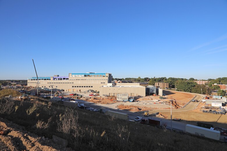 An ariel view of a large building with trees in the background.