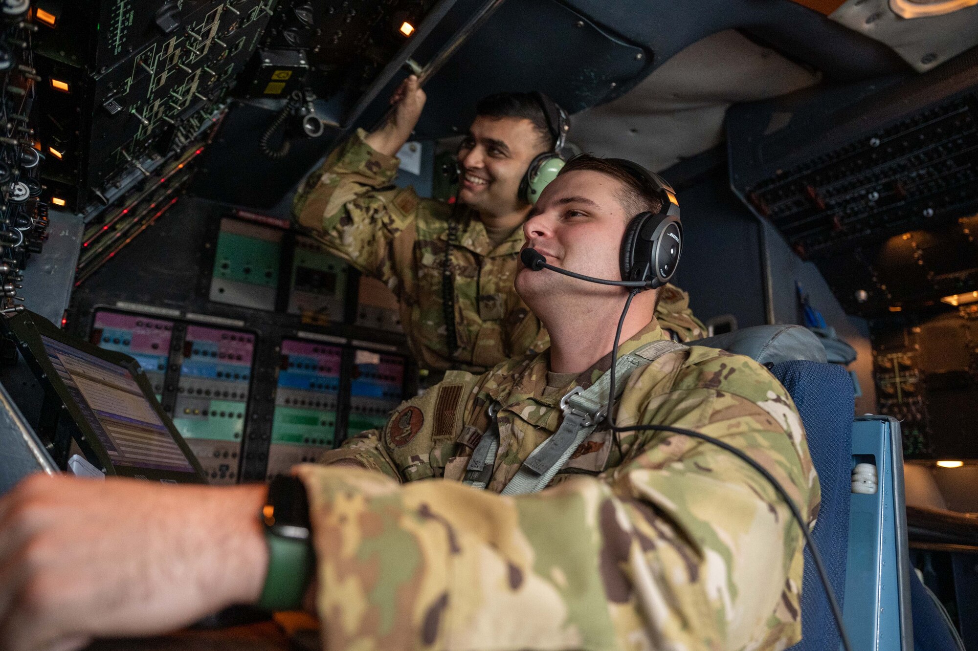 From the right, Staff Sgt. Tyler Hill and Staff Sgt. Faizan Farooq, 9th Airlift Squadron flight engineers, monitor flight panels during a training flight aboard a C-5M Super Galaxy over Pennsylvania, Jan. 4, 2023. Aircrew from the 9th AS retrieved a Dover Air Force Base C-5 from Westover Air Reserve Base, Massachusetts, where it was undergoing maintenance in the isochronal dock. (U.S. Air Force photo by Senior Airman Faith Barron)