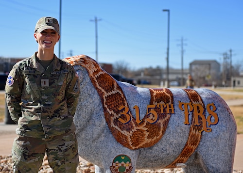 Space Force 2nd Lt. Emily Riter stands by the 315th Training Squadron sheep at Goodfellow Air Force Base, Texas, Jan. 4, 2023. Riter uses her experiences growing up in a military family to help others see how their job and other jobs affect the mission. (U.S. Air Force photo by Airman 1st Class Sarah Williams)
