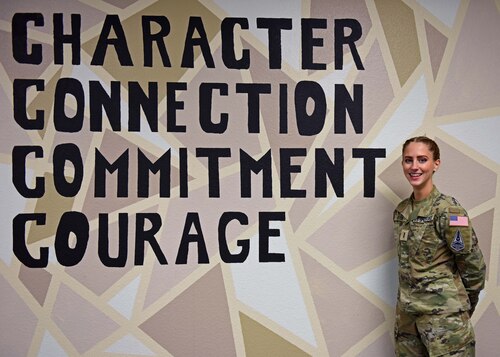 Space Force 2nd Lt. Emily Riter poses beside the Space Force core values at Goodfellow Air Force Base, Texas, Jan. 4, 2023. Space Force core values were announced on Sept. 21, 2021. (U.S. Air Force photo by Airman 1st Class Sarah Williams)