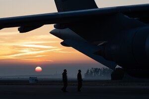 airmen walking towards an airplane