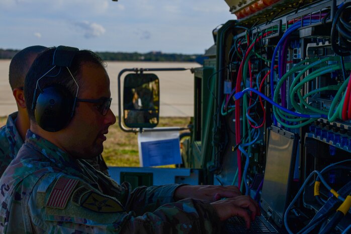 A photo of Airmen working on communications equipment.