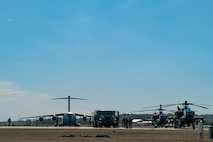 A photo of a C-17, refueling truck and two Apache helicopters