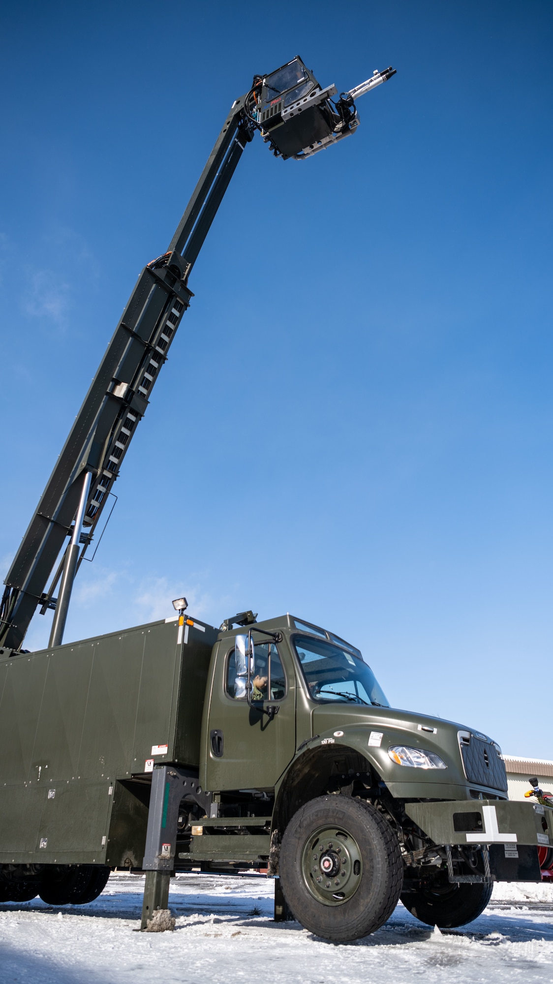 U.S. Airmen assigned to the 35th Logistics Readiness Squadron operate an extended deicer at Misawa Air Base, Japan, Dec. 20, 2022. After the primary deicer broke down beyond repair, 35th Logistics Readiness Squadron members coordinated the arrival of a new deicer to resume the mission of clearing off Misawa Air Bases’ F-16 Fighting Falcons. (U.S. Air Force photo by Staff Sgt. Kristen Heller)