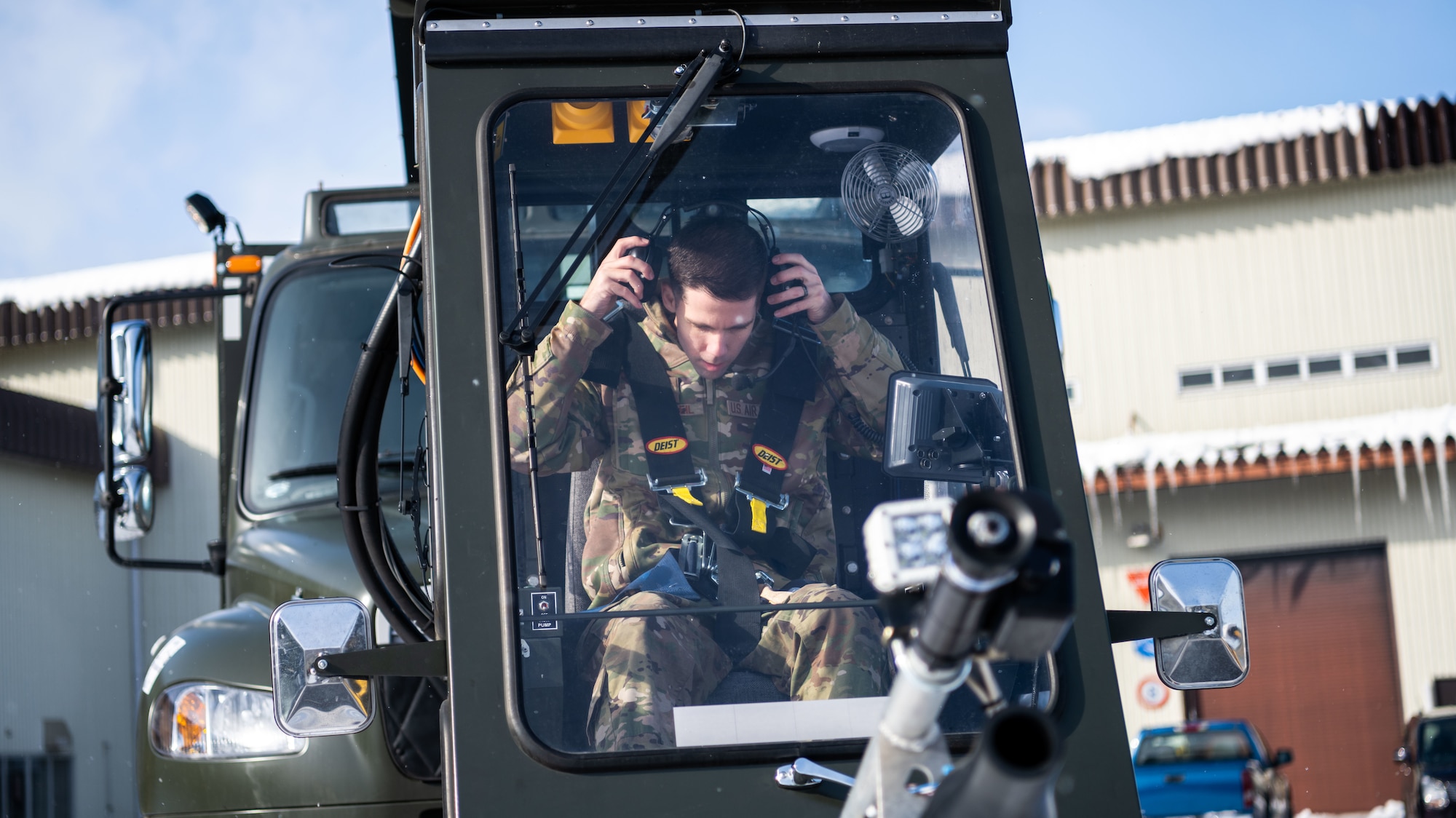 U.S. Airmen assigned to the 35th Logistics Readiness Squadron operate an extended deicer at Misawa Air Base, Japan, Dec. 20, 2022. After the primary deicer broke down beyond repair, 35th Logistics Readiness Squadron members coordinated the arrival of a new deicer to resume the mission of clearing off Misawa Air Bases’ F-16 Fighting Falcons. (U.S. Air Force photo by Staff Sgt. Kristen Heller)