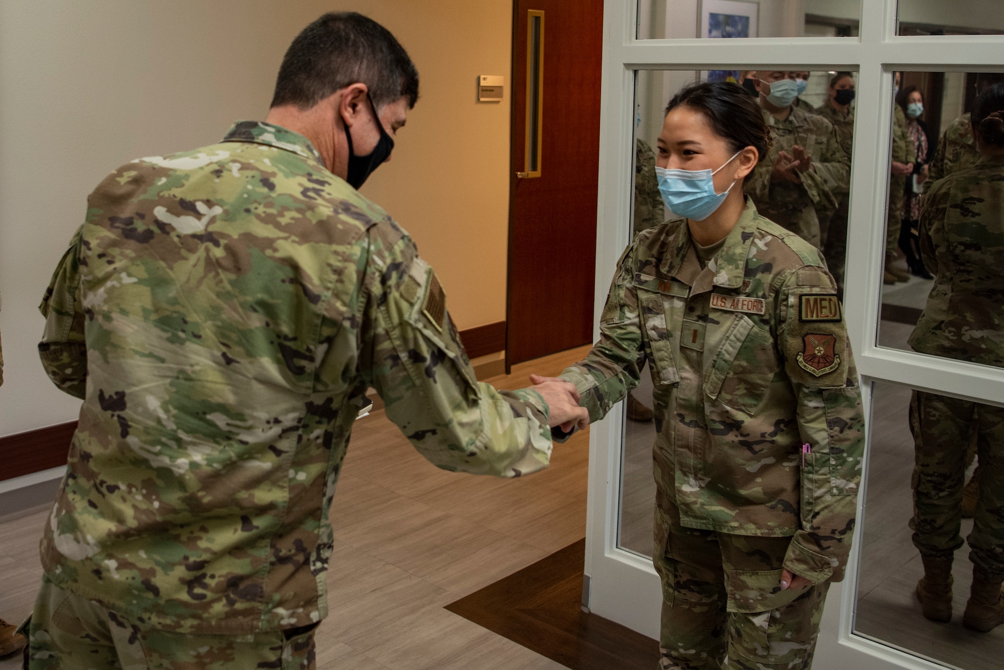 Maj. Gen. Andrew Gebara, 8th Air Force and Joint-Global Strike Operations Center commander, coins 2nd Lt. Serena Kim, 7th Healthcare Operations Squadron TRICARE operations and patient administration flight commander, during a base visit at Dyess Air Force Base, Texas, Jan. 6, 2023. Kim had identified discrepancies in the diagnosis paperwork to ensure children with autism get the care they need to receive. (U.S. Air Force photo by Airman 1st Class Ryan Hayman)