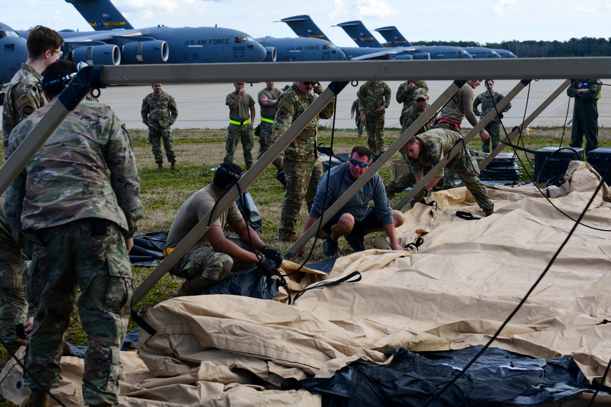 A photo of a group of people building a tent.