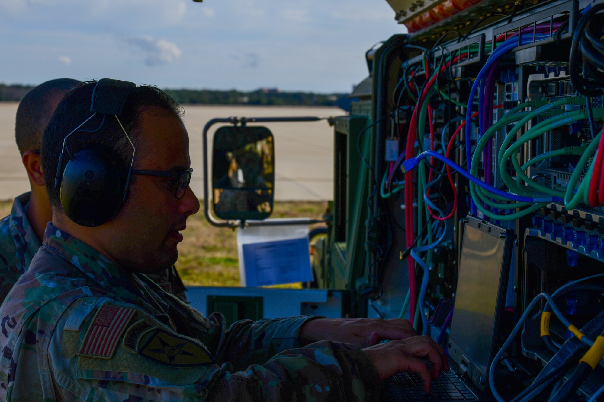 A photo of Airmen working on communications equipment.