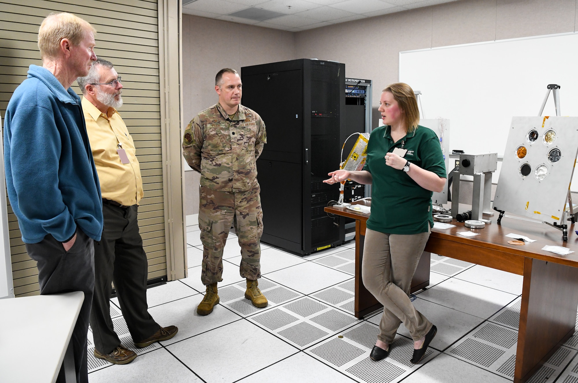 Lindsay Anderson, Arnold Engineering Development Complex flight chief for space asset resilience, 718th Test Squadron, speaks to three gentlemen standing at left about the space chambers located at Arnold Air Force Base.