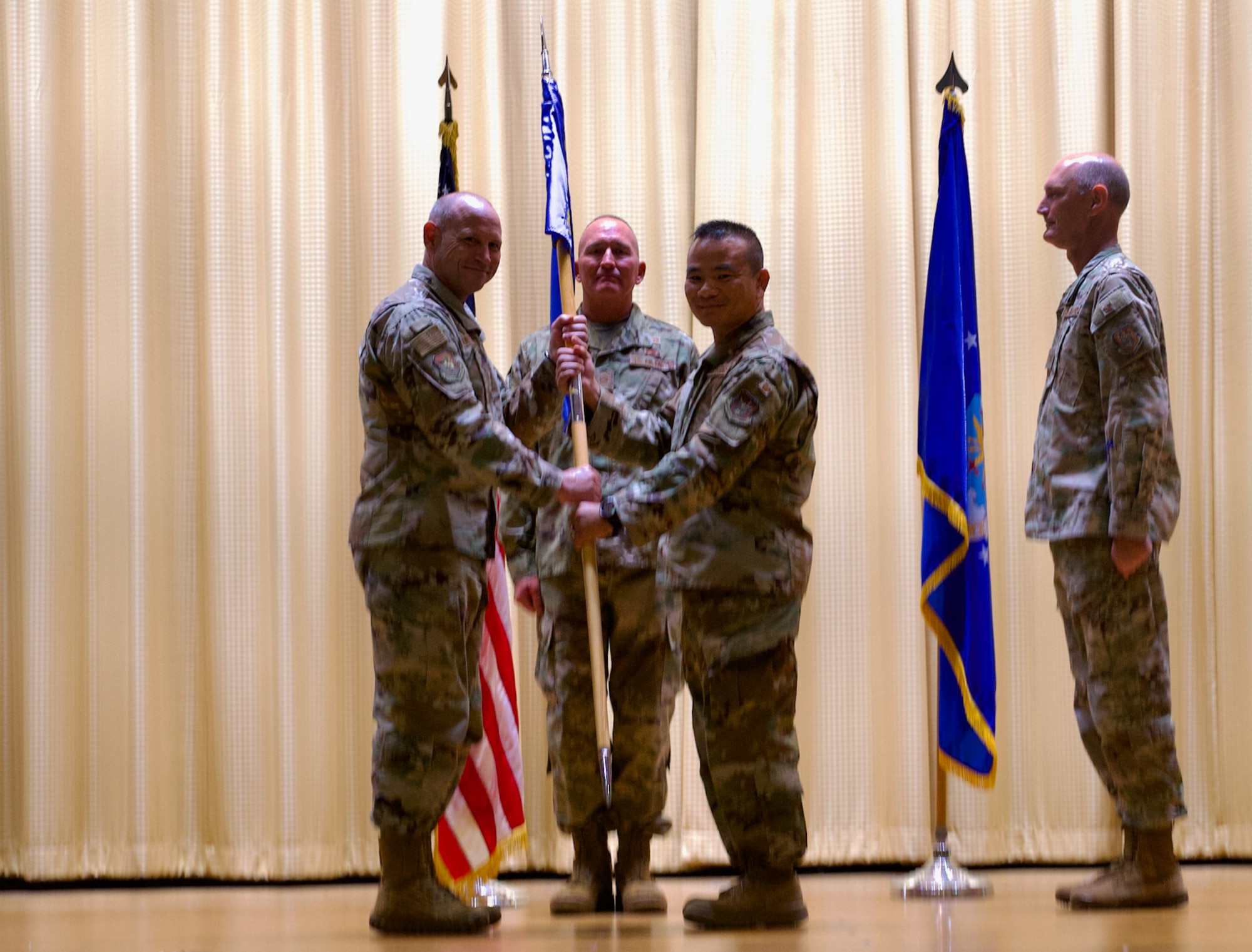 An Air Force wing commander passes the guidon to an Air Force group commander.