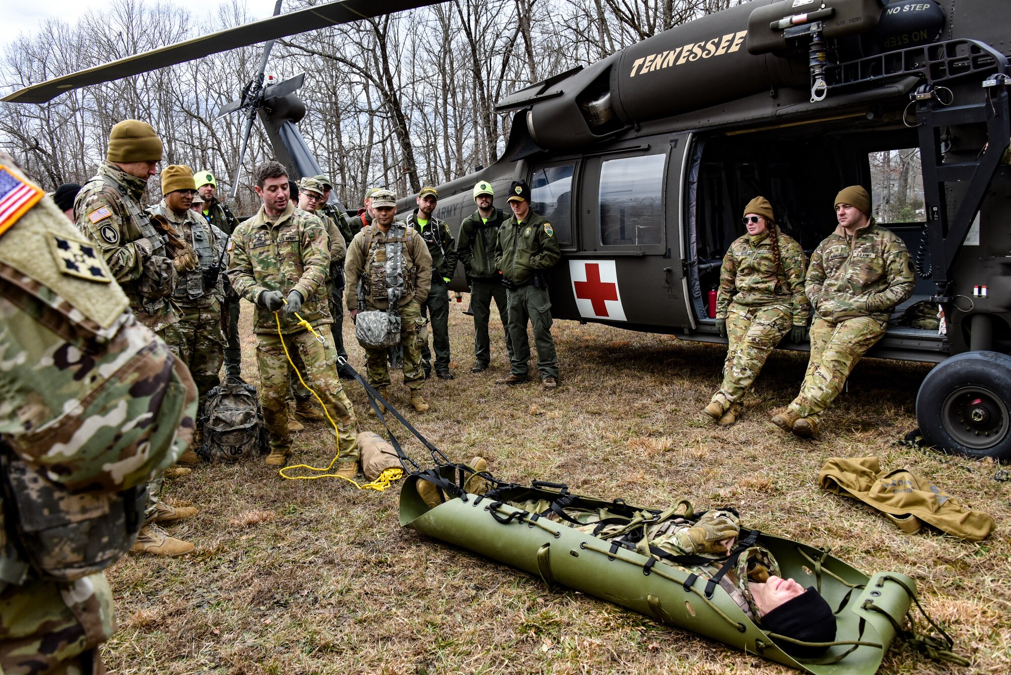a group of soldiers listen to training around a Blackhawk helicopter