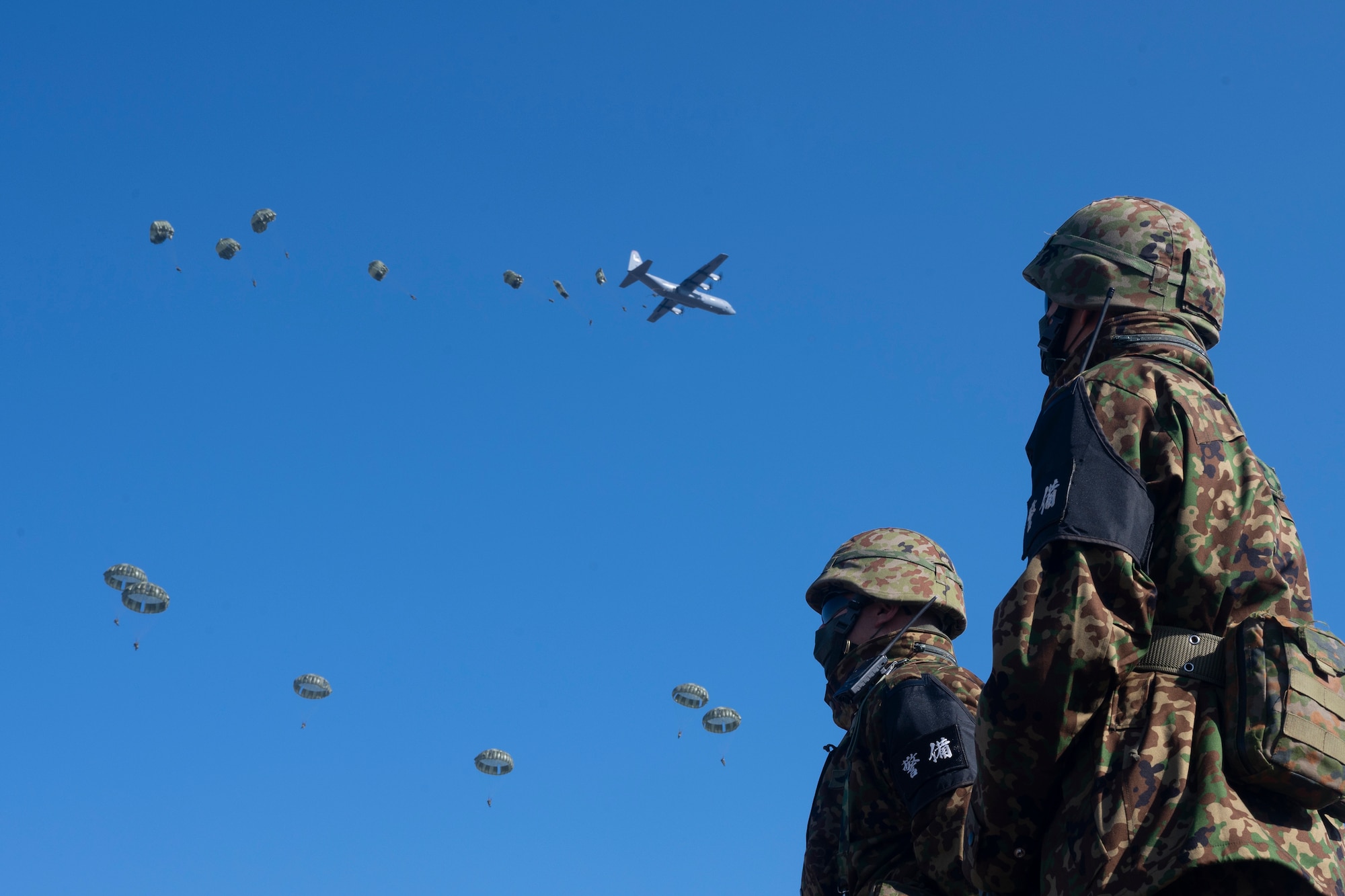 Paratroopers jump out of a C-130J