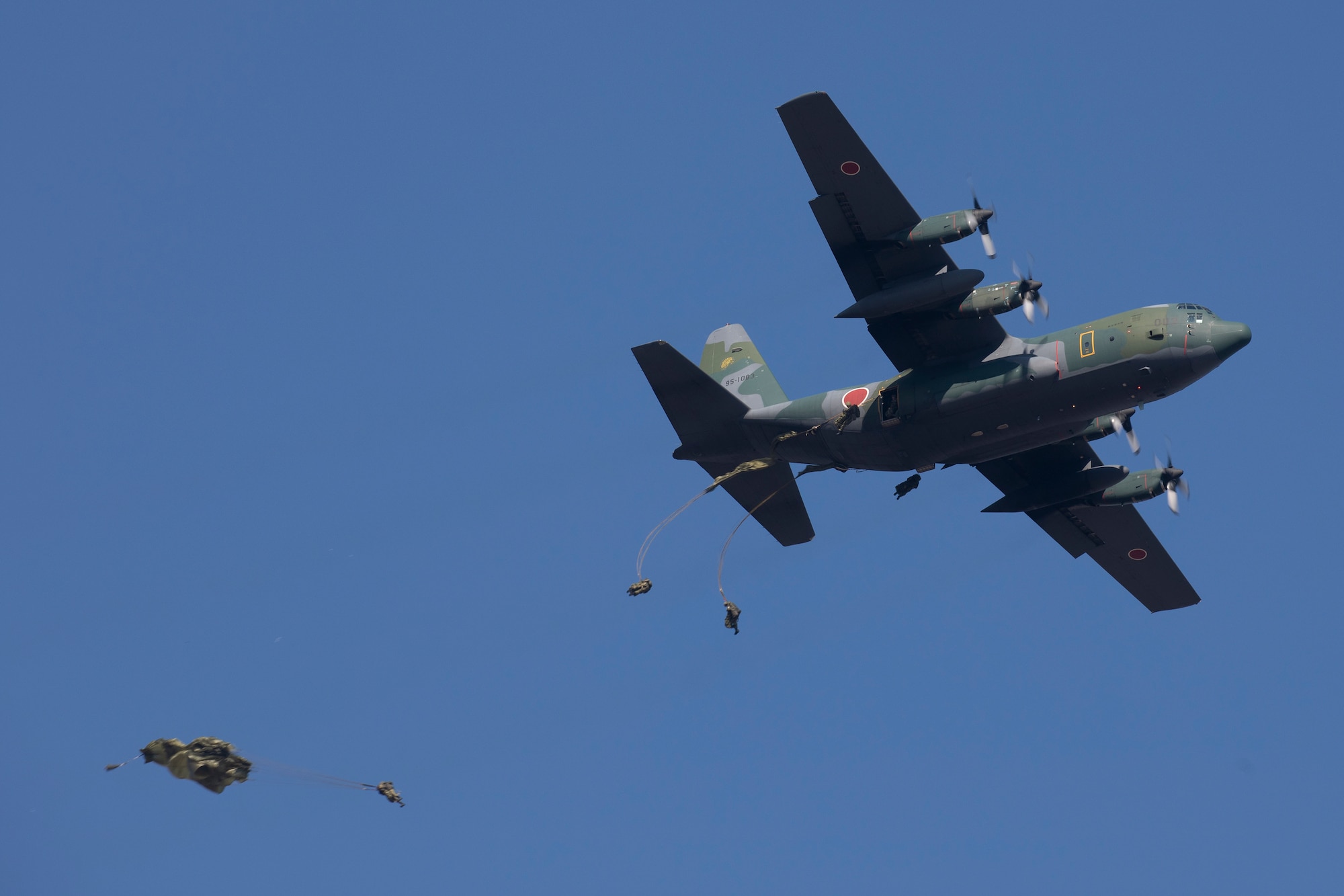 Paratroopers jump out of a C-130H