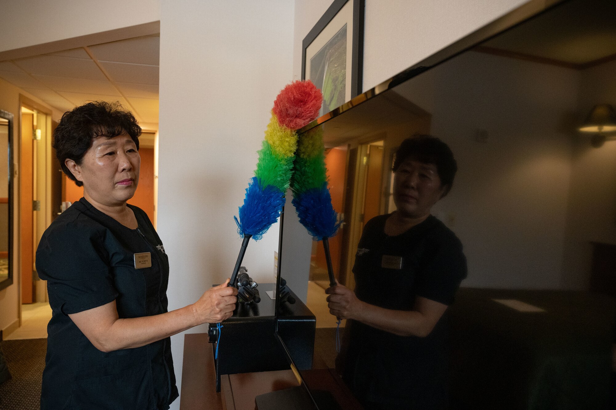 Kwi Ye Yi, 8th Force Support Squadron custodial worker, dusts a TV in the Wolf Pack Lodge at Kunsan Air Base, Republic of Korea, Jan. 5, 2023. The Wolf Pack Lodge has more than 180 rooms and includes several distinguished visitor suites. (U.S. Air Force photo by Staff Sgt. Sadie Colbert)