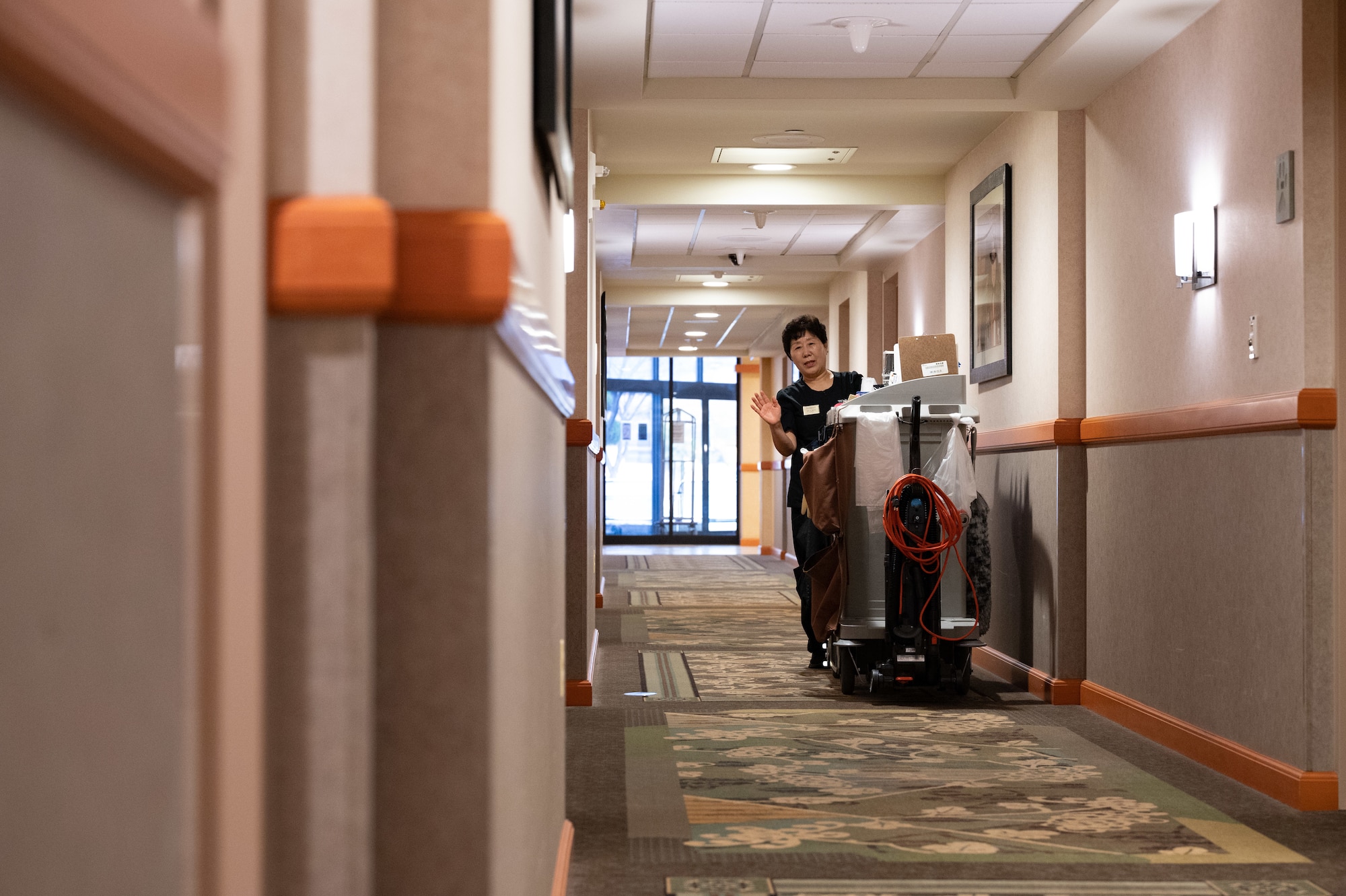 Kwi Ye Yi, 8th Force Support Squadron custodial worker, pushes a cleaning cart in the Wolf Pack Lodge at Kunsan Air Base, Republic of Korea, Jan. 5, 2023. The Wolf Pack Lodge consistently stays above 80 percent capacity due to Kunsan’s high changeover rate. (U.S. Air Force photo by Staff Sgt. Sadie Colbert)