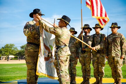 Lt. Col. Ralph E. Schneider IV, Battalion Commander of the 15th Finance Battalion (left), and Command Sgt. Maj. Ronald B. Oyardo, Command Sgt. Maj. of the 15th Finance Battalion (right), 15th Finance Battalion, uncase the Battalion Colors, signifying the definitive beginning of a unit history on August 17, 2022, at Fort Hood, Texas.  The activation ceremony is significant because the 15th Finance Battalion, originally called the 15th Finance Company, was assigned to the 1st Cavalry Division when it was first created on March 15, 1971, before it was redesignated.  (Photo by U.S. Army SGT Froylan Grimaldo, 1st Cavalry Division Public Affairs)