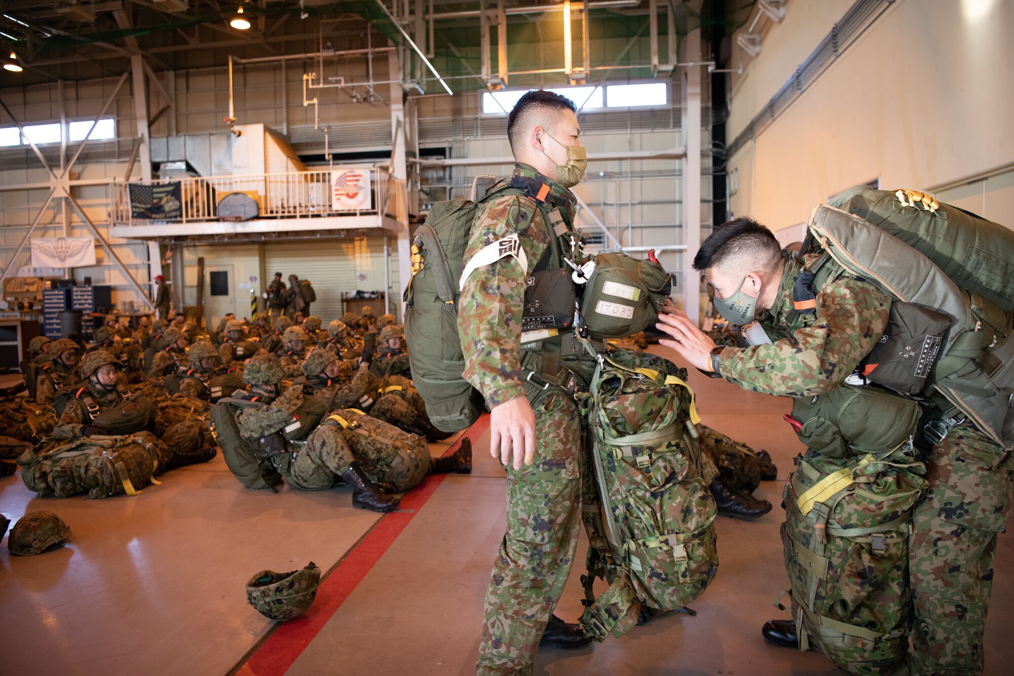 Paratroopers don their gear