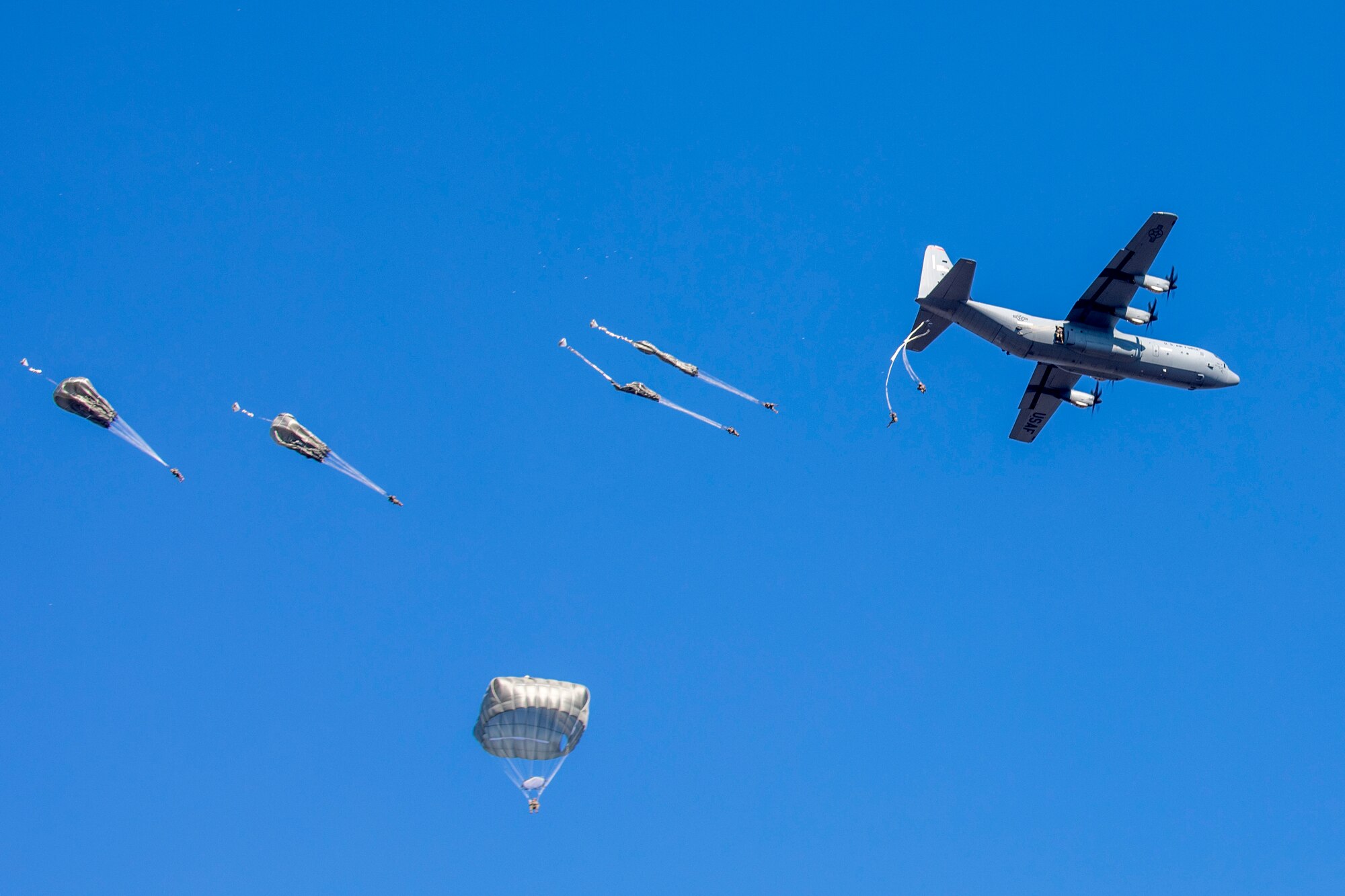 Paratroopers jump out of a C-130J