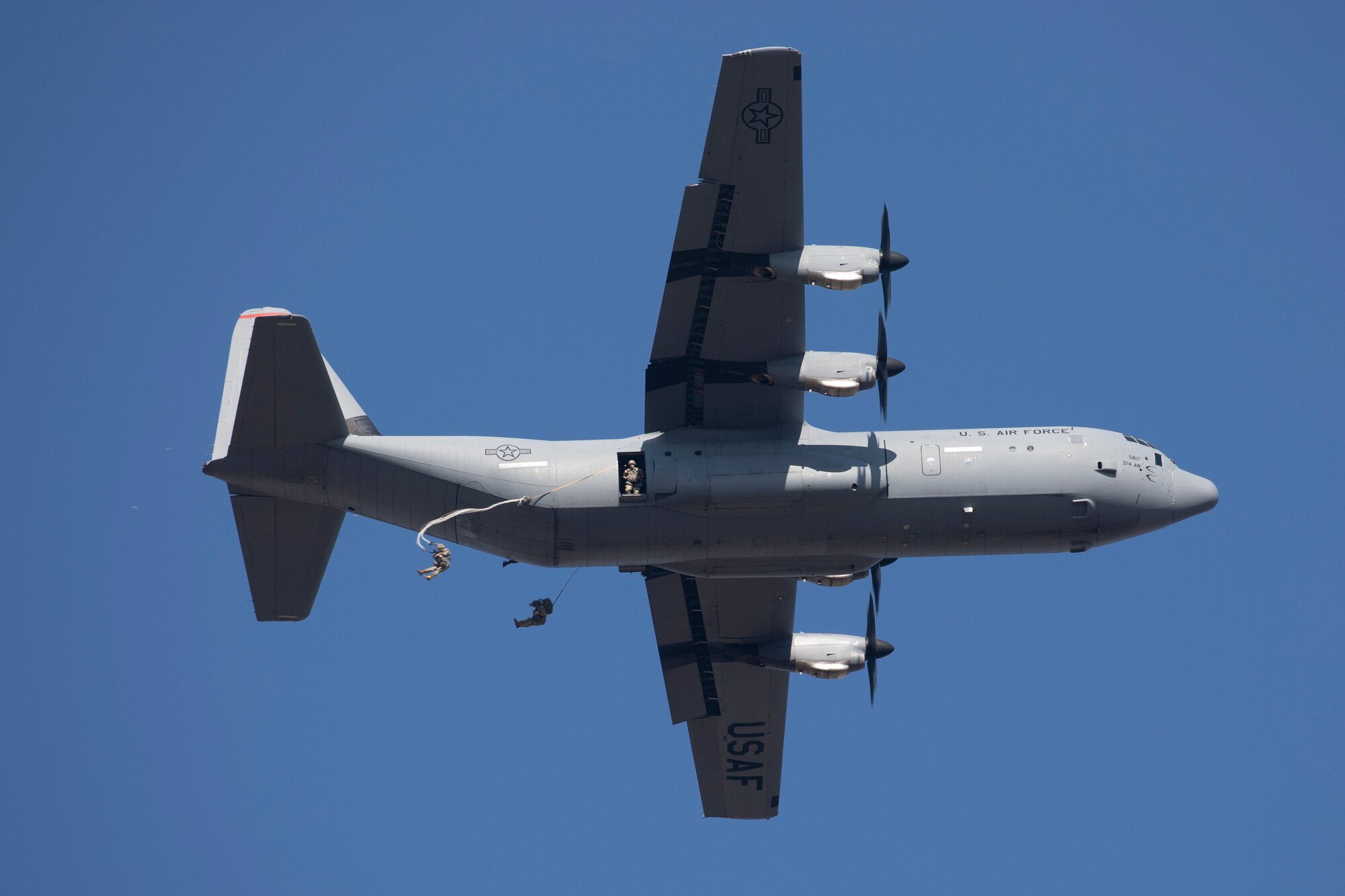 Paratroopers jump out of a C-130J