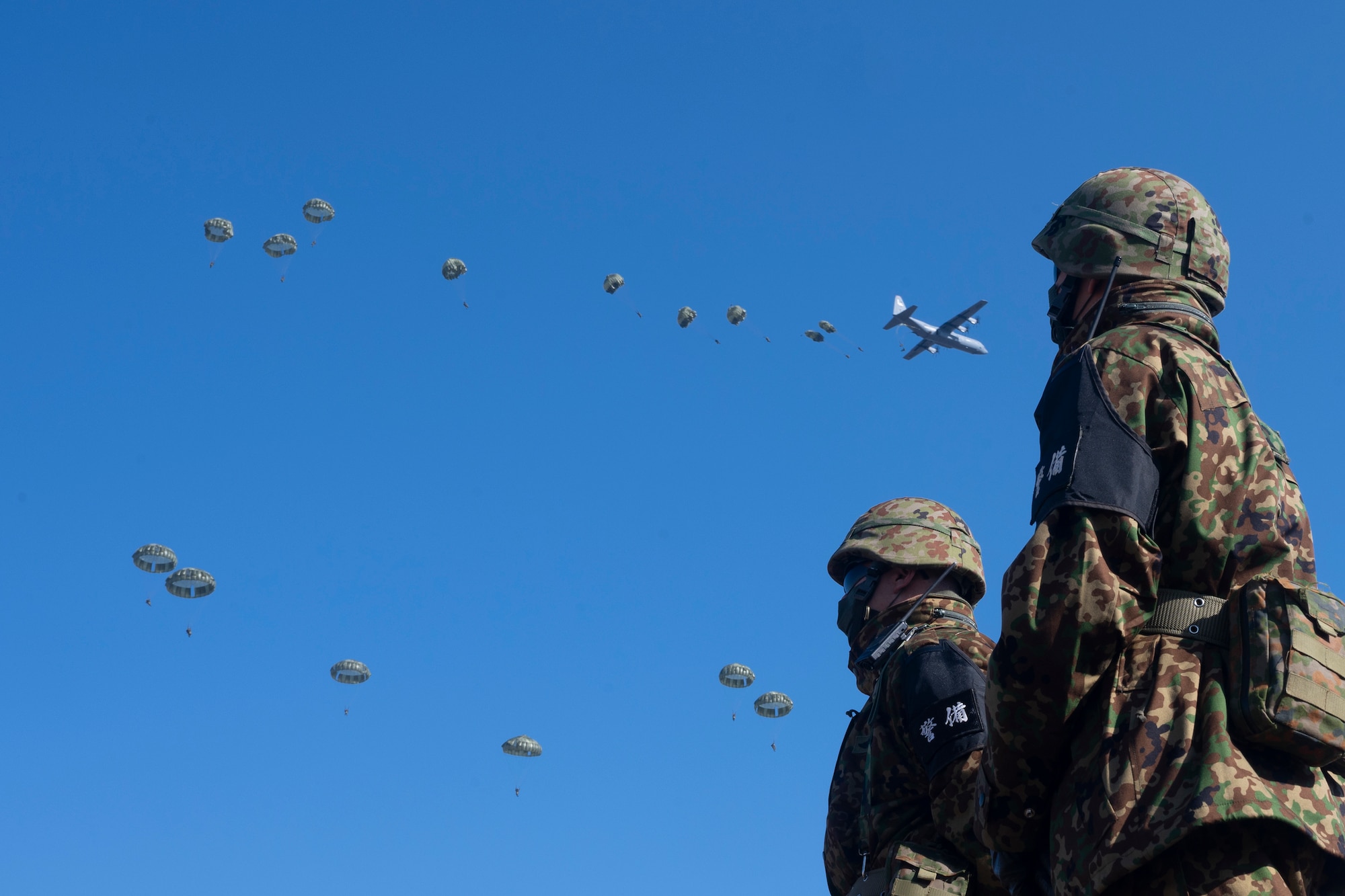 Paratroopers jump out of a C-130J