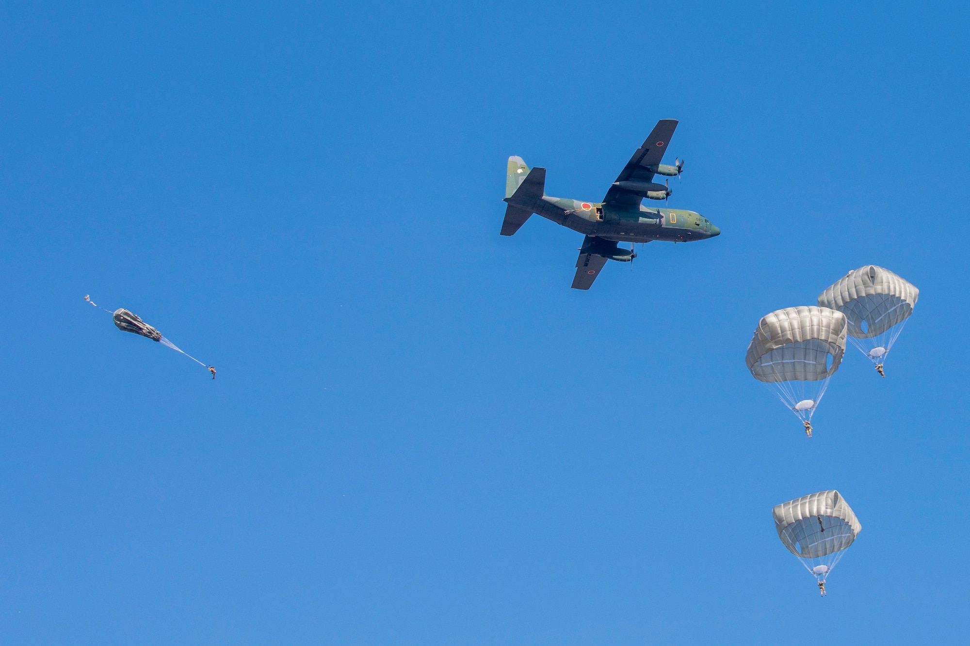 Paratroopers jump out of a C-130H