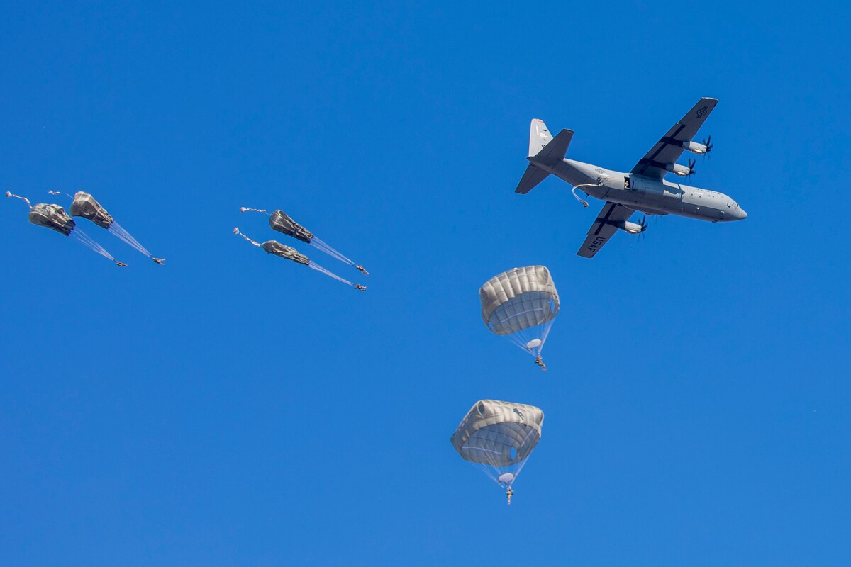 Paratroopers jump out of a C-130J