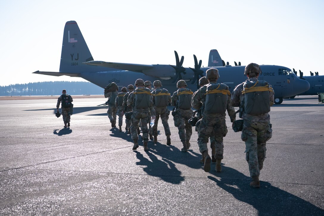 Paratroopers walk to a C-130J
