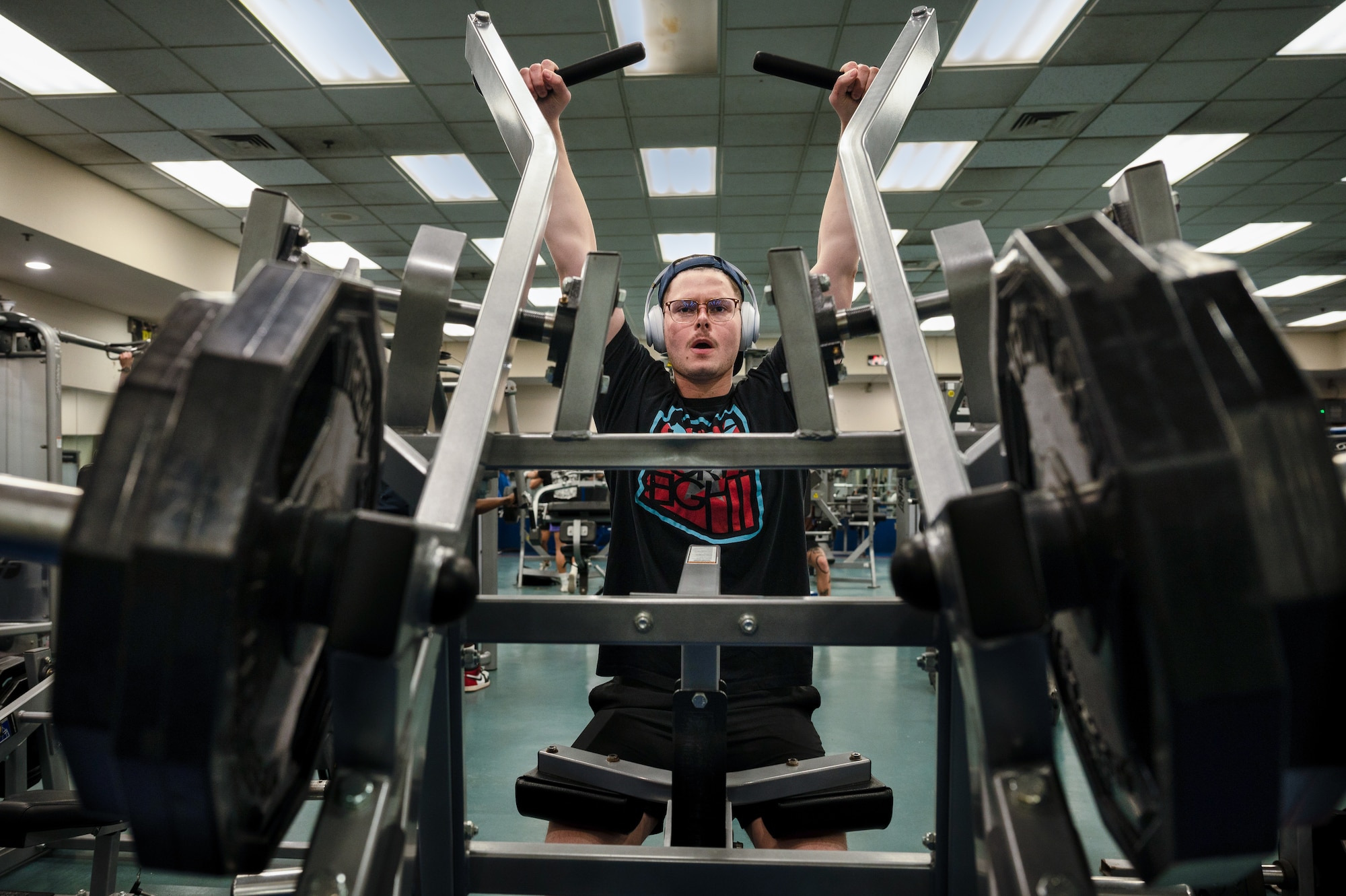 U.S. Air Force Airman 1st Class Aaron Edwards, 51st Fighter Wing public affairs specialist performs lateral pull-downs during a back and bicep workout at the fitness center on Osan Air Base, Republic of Korea, Dec. 30, 2022. The 51st Force Support Squadron fitness center is accessible 24/7 with manned hours Monday through Friday 5 a.m. through 10 p.m. and Saturdays 8 a.m. through 5 p.m. The center is also open during unmanned hours including Sundays, holidays and down days. (U.S. Air Force Photo by Staff Sgt. Dwane Young)