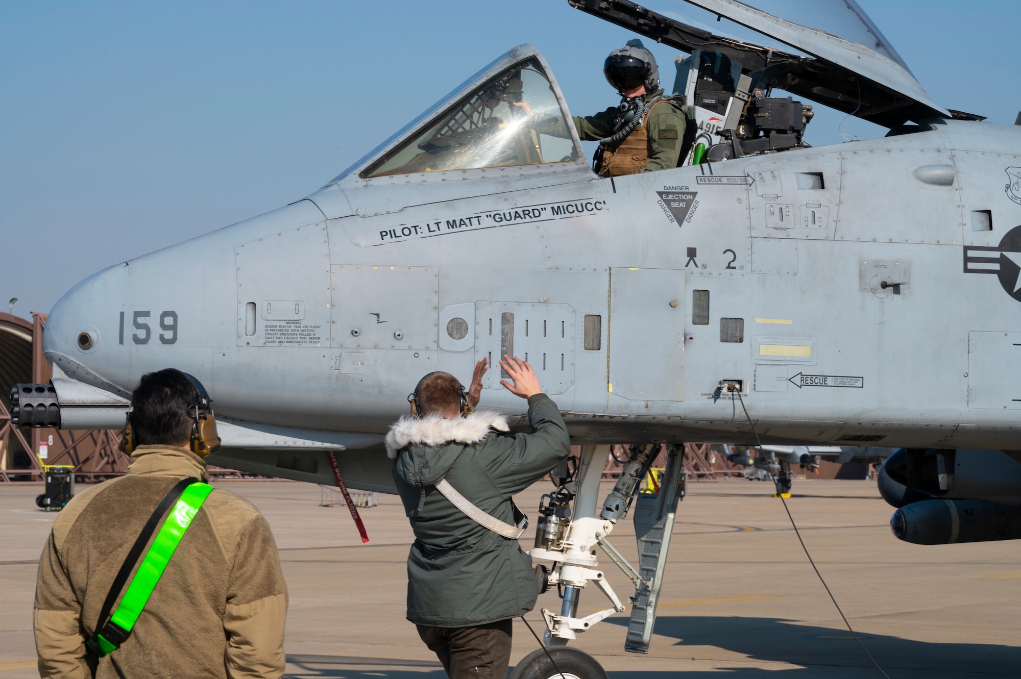 U.S. Air Force Senior Airman Tristan Barker, 25th Fighter Generation Squadron crew chief, signals an A-10 pilot after a training mission at Osan Air Base, Republic of Korea, Jan. 4, 2023.