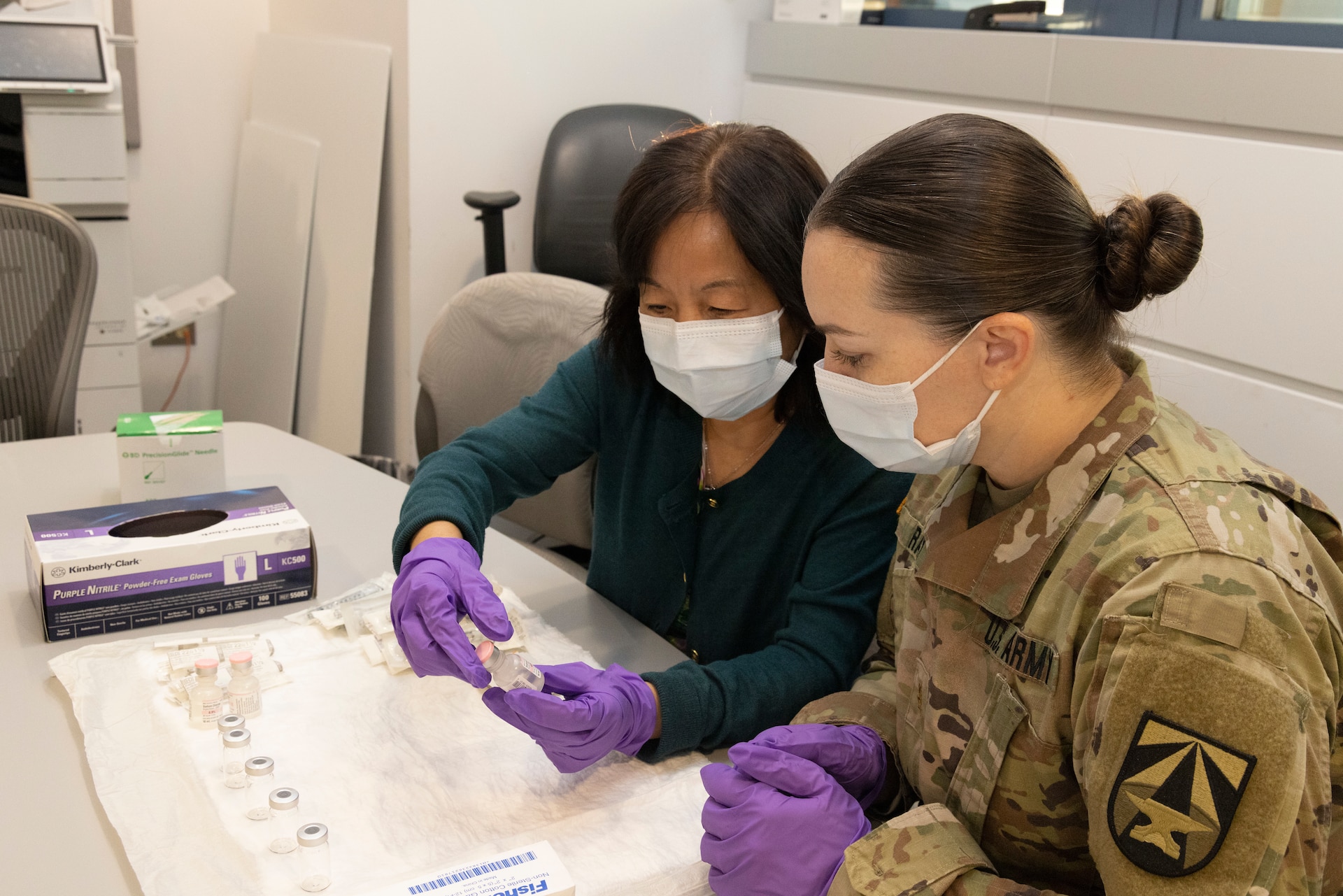 Lei Zhu and MAJ kelly Ray prepare samples